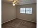 Bright bedroom with carpeted floor, ceiling fan, and large window at 203 47Th Avenue W Dr # 167, Bradenton, FL 34207