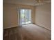 Bedroom with sliding doors to patio and ceiling fan at 203 47Th Avenue W Dr # 167, Bradenton, FL 34207