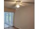 Bedroom with sliding glass doors to a patio and ceiling fan at 203 47Th Avenue W Dr # 167, Bradenton, FL 34207