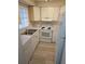 Efficient kitchen featuring white appliances and wood-look floors at 203 47Th Avenue W Dr # 167, Bradenton, FL 34207