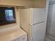 White kitchen appliances and cabinetry, with access to the living room at 203 47Th Avenue W Dr # 167, Bradenton, FL 34207