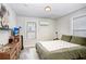 Main bedroom with a green comforter and wood dresser at 2483 13Th N Ave, St Petersburg, FL 33713