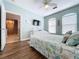 Charming bedroom with wood floors, a comfortable bed, and an open doorway to the main living area at 2724 Via Murano # 633, Clearwater, FL 33764