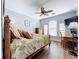 Bright bedroom with king-size bed, wood floors, and ceiling fan at 2724 Via Murano # 633, Clearwater, FL 33764