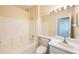 Clean bathroom with tub, toilet and single vanity at 30237 Lettingwell Cir, Wesley Chapel, FL 33543