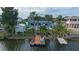 Aerial view of waterfront home with private dock and lush landscaping at 3270 Hibiscus Dr, Hernando Beach, FL 34607