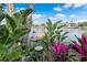 Private backyard oasis with lush tropical plants and a waterfront dock at 3270 Hibiscus Dr, Hernando Beach, FL 34607