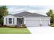 Two-story house with gray siding, two-car garage, and landscaping at 4315 Pullet Ct, Lakewood Ranch, FL 34211