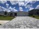 Charming single-story home featuring a two-car garage and a patterned brick driveway at 4315 Pullet Ct, Lakewood Ranch, FL 34211