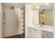 Bathroom with vanity, sink, and large mirror at 440 S Gulfview Blvd # 905, Clearwater Beach, FL 33767