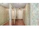 Long entryway with mirrored walls and carpet at 440 S Gulfview Blvd # 905, Clearwater Beach, FL 33767