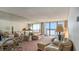 Spacious living room with water views and mirrored walls at 440 S Gulfview Blvd # 905, Clearwater Beach, FL 33767