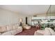 Living room and adjacent dining area with light colored furniture at 440 S Gulfview Blvd # 905, Clearwater Beach, FL 33767