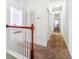 Upstairs hallway with carpeted floors and multiple doors to bedrooms and closets at 472 Harbor Ridge Dr, Palm Harbor, FL 34683