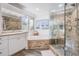 Bathroom with a large walk-in shower and a corner soaking tub at 5203 Green Forest Ct, Tampa, FL 33647