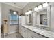 Double vanity bathroom with granite countertops and a walk-in shower at 5205 Covesound Way, Apollo Beach, FL 33572