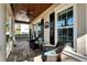 Relaxing front porch with wicker chairs and a glass-top table at 5205 Covesound Way, Apollo Beach, FL 33572