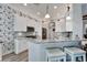 Modern kitchen with white cabinets, granite countertops and stainless steel appliances at 5205 Covesound Way, Apollo Beach, FL 33572