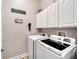 Laundry room with washer, dryer, and upper cabinets at 5205 Covesound Way, Apollo Beach, FL 33572