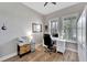 Home office with built-in shelving and hardwood floors at 5205 Covesound Way, Apollo Beach, FL 33572