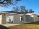 House exterior showcasing a patio and grassy backyard at 5338 James St, New Port Richey, FL 34652