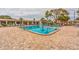 Community pool with plenty of lounge chairs at 5603 80Th N St # 107, St Petersburg, FL 33709