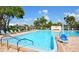 Community pool with lounge chairs and lift access at 5603 80Th N St # 107, St Petersburg, FL 33709