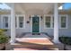 Green front door with columns and a tiled porch at 5608 N 9Th St, Tampa, FL 33604