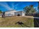 House exterior showcasing a well-maintained lawn, deck, and attached garage at 5610 13Th N Ave, St Petersburg, FL 33710