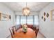 Well-lit dining room with bay window and a round wooden dining table at 5970 Hillside St, Seminole, FL 33772