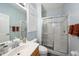 Bright bathroom with walk-in shower, vanity, and updated fixtures at 8507 Portage Ave, Tampa, FL 33647