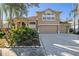 Two-story house with a three-car garage and lush landscaping at 8507 Portage Ave, Tampa, FL 33647
