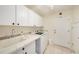 Convenient laundry room with washer, dryer, and extra storage at 8507 Portage Ave, Tampa, FL 33647