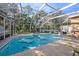 Inviting pool area with screened enclosure, perfect for relaxation at 8507 Portage Ave, Tampa, FL 33647