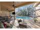 Inviting pool area with screened enclosure, patio furniture, and grill at 8507 Portage Ave, Tampa, FL 33647