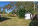 Backyard with a shed, wooden fence, and grassy area at 10273 109Th Ave, Largo, FL 33773