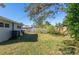 Large backyard with a wooden fence and storage shed at 10273 109Th Ave, Largo, FL 33773