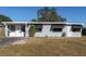 Front view of a freshly painted gray house with awnings at 10273 109Th Ave, Largo, FL 33773
