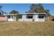 Gray house with a well-maintained lawn and mature trees at 10273 109Th Ave, Largo, FL 33773