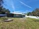 House backyard with patio and grassy area at 1116 Carmona Ave, Spring Hill, FL 34608