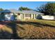 Single-story house with metal roof and attached garage at 1116 Carmona Ave, Spring Hill, FL 34608