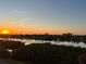 Stunning sunset over calm water with waterfront homes at 11730 Shipwatch Dr # 503, Largo, FL 33774