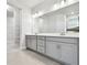 Elegant bathroom featuring double vanity and grey cabinets at 11815 Richmond Trl, Parrish, FL 34219