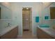 Modern bathroom with double sinks and a separate tub at 119 8Th E St, Tierra Verde, FL 33715
