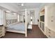 Main bedroom with a large four-poster bed, ample closet space, and ensuite bathroom at 119 8Th E St, Tierra Verde, FL 33715