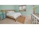 Cozy bedroom with light green walls and wood-toned dresser at 119 8Th E St, Tierra Verde, FL 33715