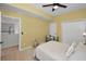 Bright bedroom with neutral walls, ceiling fan, and double doors at 119 8Th E St, Tierra Verde, FL 33715
