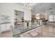 Open dining room adjacent to kitchen, features a glass table and seating for six at 119 8Th E St, Tierra Verde, FL 33715
