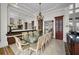 Formal dining room with large glass table and chandelier at 119 8Th E St, Tierra Verde, FL 33715