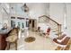Elegant two-story entry with chandelier, staircase, and wet bar at 119 8Th E St, Tierra Verde, FL 33715